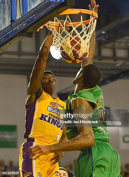 Kendrick Perry of the Kings slam dunks the ball in front of Mickell Gladness of the Crocodiles during the round 15 NBL match between the Townsville...