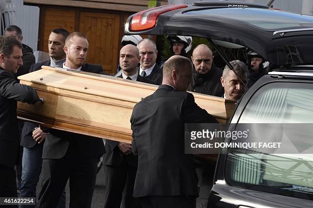 People hold the coffin of French cartoonist and Charlie Hebdo editor Stephane "Charb" Charbonnier after his funeral ceremony, on January 16, 2015 in...