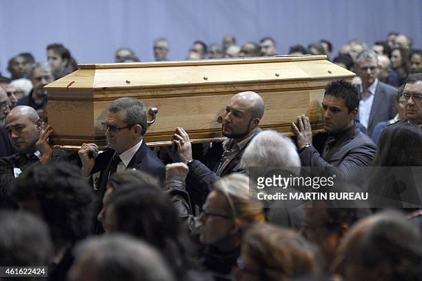 People hold the coffin of French cartoonist and Charlie Hebdo editor Stephane "Charb" Charbonnier during his funeral ceremony, on January 16, 2015 in...