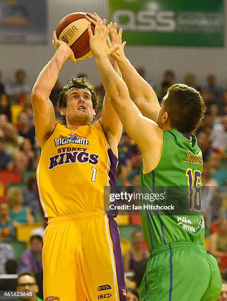 Ben Madgen of the Kings takes a jump shot over Mirko Djeric of the Crocodiles during the round 15 NBL match between the Townsville Crocodiles and...