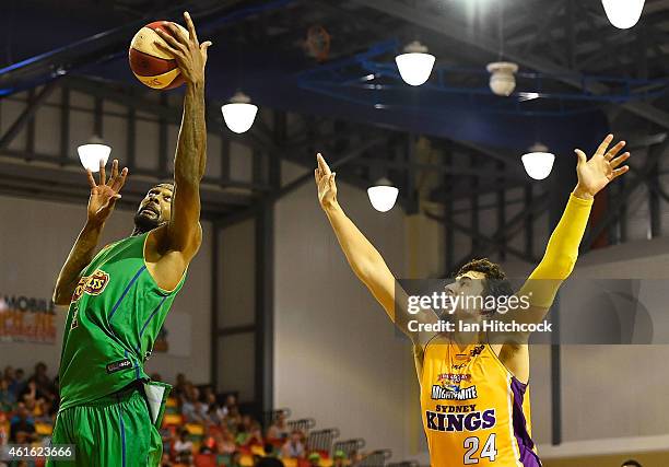 Mickell Gladness of the Crocodiles collects a re-bound in front of Cody Ellis of the Kings during the round 15 NBL match between the Townsville...