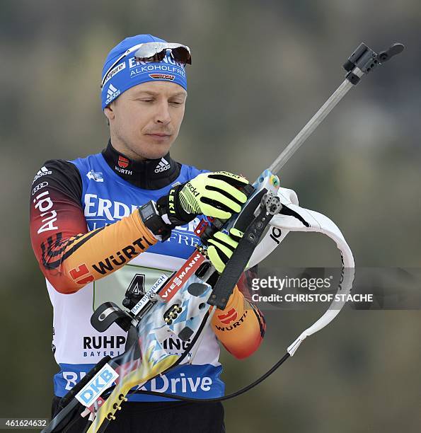 German Andreas Birnbacher prepares his gun ahead of the men's 4 x 7,5 km relay at the Biathlon World Cup on January 15 in Ruhpolding, southern...
