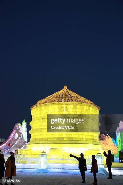 Visitors look at ice sculptures during the 2015 Harbin International Ice & Snow Sculpture Festival on January 15, 2015 in Harbin, China.