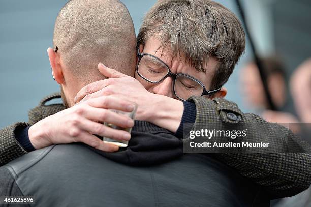 Charlie Hebdo cartoonist Renald Luzier aka 'Luz' comforts another mourner after the funeral service of Charlie Hebdo editor and cartoonist Stephane...