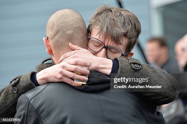 Charlie Hebdo cartoonist Renald Luzier aka 'Luz' comforts another mourner after the funeral service of Charlie Hebdo editor and cartoonist Stephane...