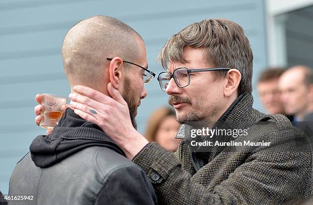 Charlie Hebdo cartoonist Renald Luzier aka 'Luz' comforts another mourner after the funeral service of Charlie Hebdo editor and cartoonist Stephane...