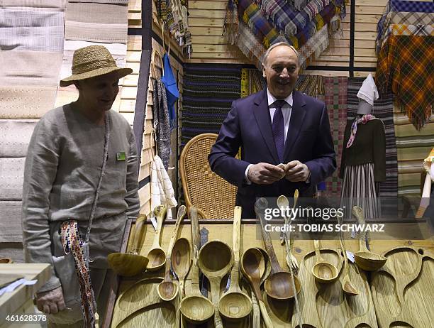 President of Latvia Andris Berzins looks at handmade products during his visit of Latvia's exhibitors during the opening day of the "Gruene Woche"...