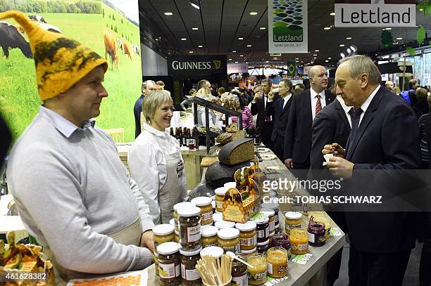 President of Latvia Andris Berzins looks at Latvian products during his visit of Latvia's exhibitors during the opening day of the "Gruene Woche"...