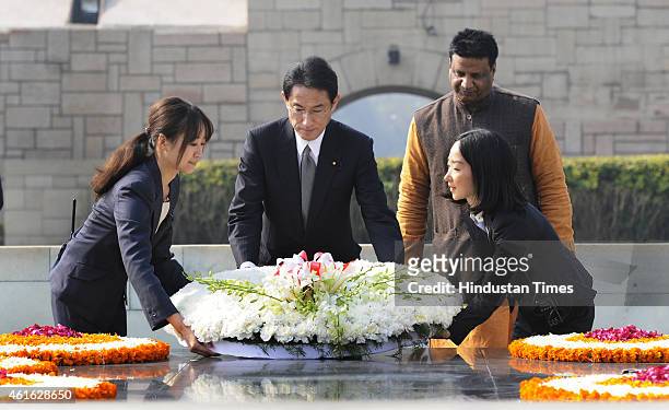 Japanese Foreign Minister Fumio Kishida paying floral tribute at the samadhi of Mahatma Gandhi at Rajghat on January 16, 2015 in New Delhi, India....