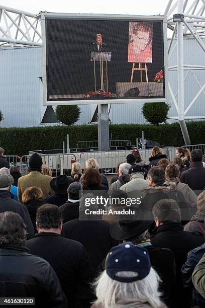 Peole gather around the large screen showing the funeral of Stephane Charbonnier, also known as Charb, the publishing director of the satirical paper...