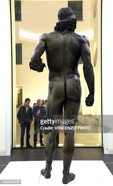 Visitors admire the 2,500-year-old Riace Bronzes displayed in a renovated Reggio Calabria National Archeological Museum on January 9 following four...