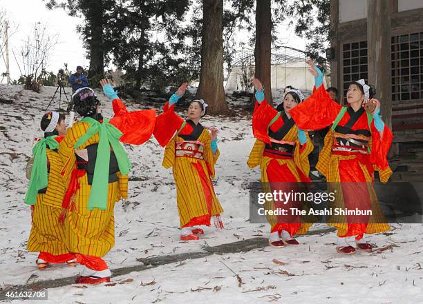 Women wearing colourful kimonos perform the 'rice planting and rice-cake making' dance at Mena Shrine in prayer for good harvest on January 12, 2015...