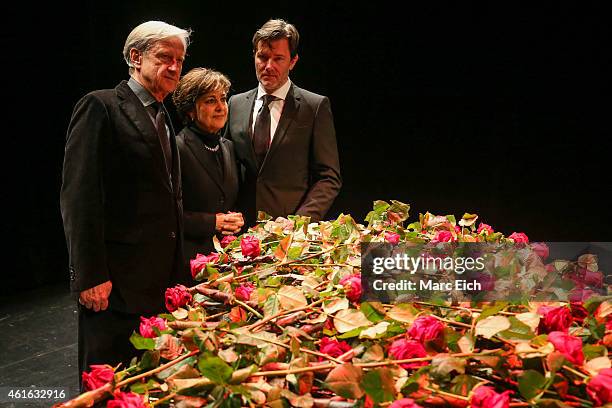 Freddy Burger, manager of Udo Juergens, Paola Felix and John Juergens, son of Udo Juergens, pose in front of a piano with roses lieing ontop at a...