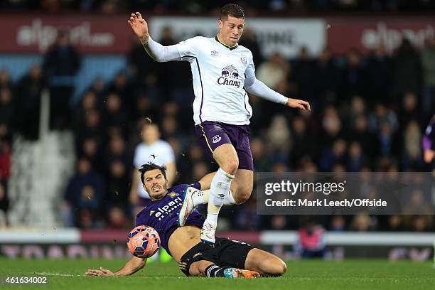 Ross Barkley of Everton in action with James Tomkins of West Ham during the FA Cup Third Round Replay match between West Ham United and Everton at...