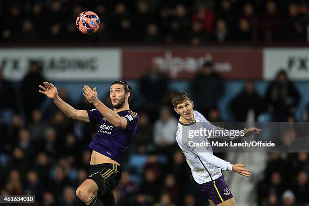 Andy Carroll of West Ham in action with John Stones of Everton during the FA Cup Third Round Replay match between West Ham United and Everton at...