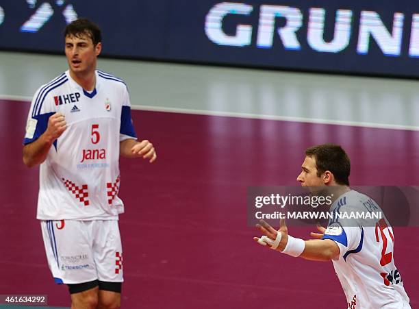 Croatia's Ivan Cupic and Domagoj Duvnjak celebrate during the 24th Men's Handball World Championships preliminary round Group B match Croatia vs...