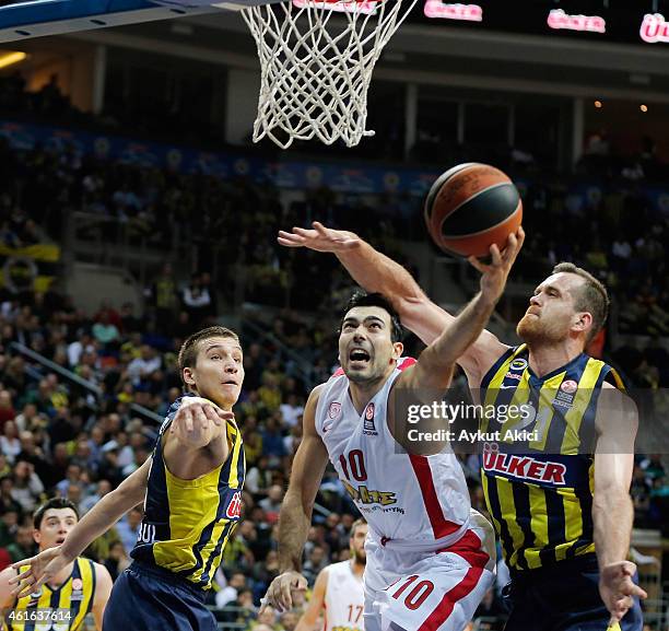 Konstantinos Sloukas, #10 of Olympiacos Piraeus competes with Oguz Savas, #21 of Fenerbahce Ulker Istanbul during the Euroleague Basketball Top 16...