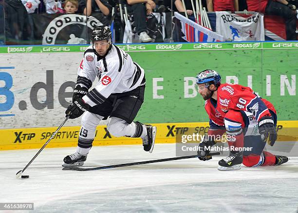 Jason Jaspers of the Thomas Sabo Ice Tigers Nuernberg and Darin Olver of the Eisbaeren Berlin in action during the game between Eisbaeren Berlin and...