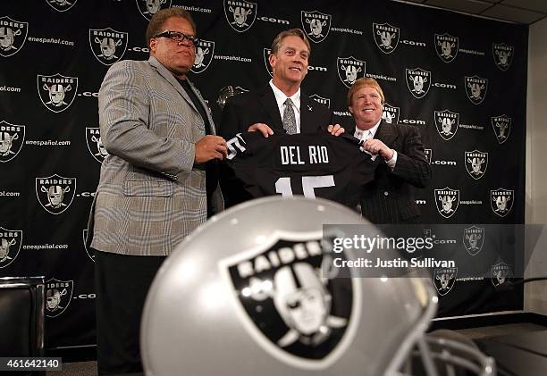 Oakland Raiders new head coach Jack Del Rio holds a jersey as he poses for a photograph with Raiders general manager Reggie McKenzie and Raiders...