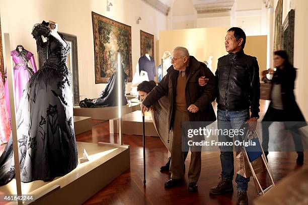 Italian costume designer Piero Tosi looks his dress worn by Laura Antonelli for the movie 'The Innocent' by Luchino Visconti during the 'I Vestiti...