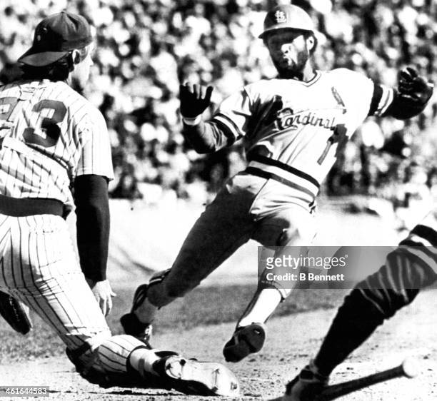 Ozzie Smith of the St. Louis Cardinals scores from second as catcher Ted Simmons of the Milwaukee Brewers can't make the tag during Game 4 of the...