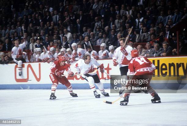 Guy Lafleur of Canada skates with the puck as he is defended by Sergei Makarov and Zinetula Bilyaletdinov of the Soviet Union during the 1981 Canada...