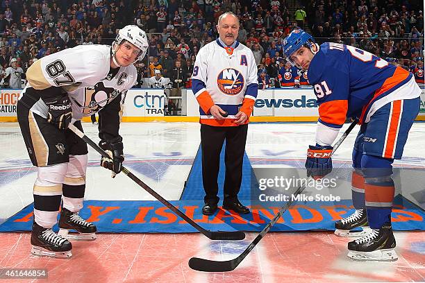 Hall of Famer and former New York Islanders player Bryan Trottier takes part in a ceremonial puck drop with John Tavares of the New York Islanders...