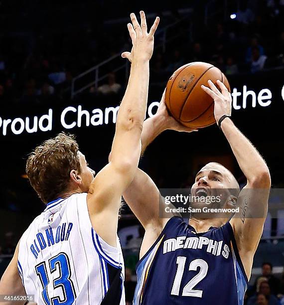 Nick Calathes of the Memphis Grizzlies attempts a shot over Luke Ridnour of the Orlando Magic during the game at Amway Center on January 16, 2015 in...