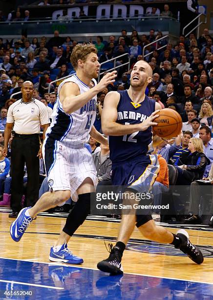 Nick Calathes of the Memphis Grizzlies drives against Luke Ridnour of the Orlando Magic during the game at Amway Center on January 16, 2015 in...