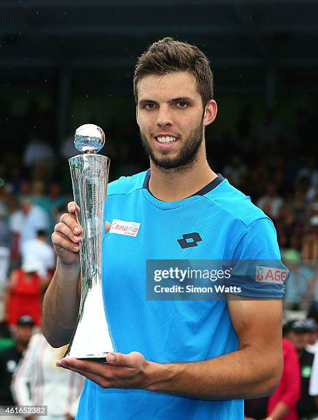 Jiri Vesely of the Czech Republic poses with the Heineken Open trophy after winning his singles final match against Adrian Mannarino of France during...