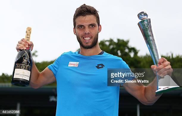 Jiri Vesely of the Czech Republic poses with the Heineken Open trophy after winning his singles final match against Adrian Mannarino of France during...