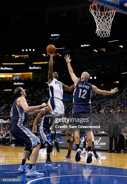 Ben Gordon of the Orlando Magic attempts a shot over Nick Calathes of the Memphis Grizzlies during the game at Amway Center on January 16, 2015 in...