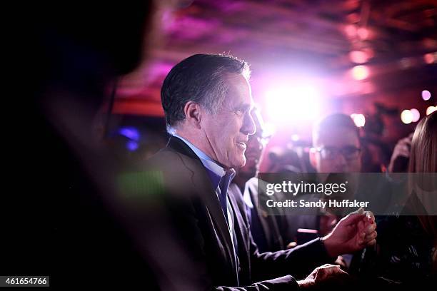 Mitt Romney is greeted by fellow Republicans at a dinner during the Republican National Committee's Annual Winter Meeting aboard the USS Midway on...