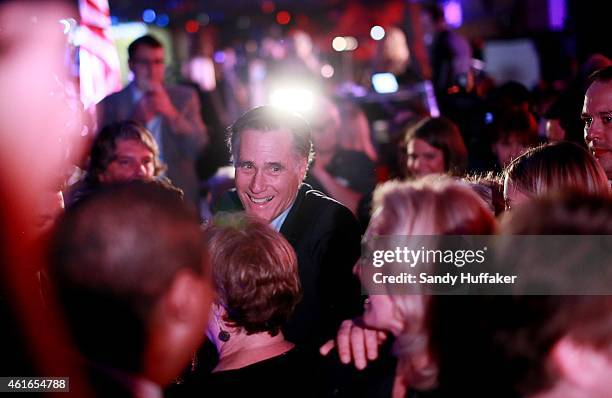 Mitt Romney is greeted by fellow Republicans at a dinner during the Republican National Committee's Annual Winter Meeting aboard the USS Midway on...