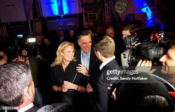 Mitt Romney shakes hands with supporters with his wife Ann at a dinner during the Republican National Committee's Annual Winter Meeting aboard the...