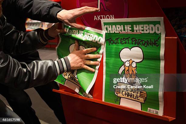 Kenny Rebenstock and Nico Hirte grab the only two issues of the French satirical magazine Charlie Hebdo, the first published after the recent Paris...