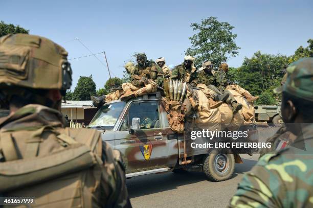 Pick up with Chadian soldiers part of the Misca drives past French soldiers part of the Sangaris operation on January 10, 2014 in Bangui. The Central...
