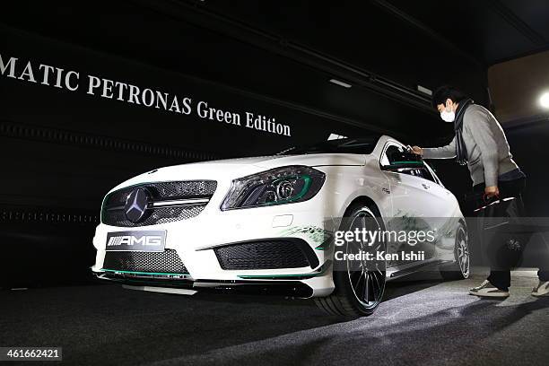 An attendee examines a Mercedes-Benz A 45 AMG displayed at the Tokyo Auto Salon 2014 at Makuhari Messe on January 10, 2014 in Chiba, Japan. The Tokyo...