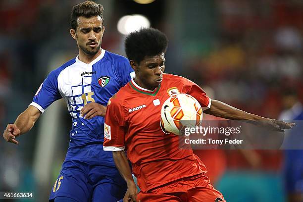 Faisal Alenezi of Kuwait contests the ball with Raed Saleh of Oman during the 2015 Asian Cup match between Oman and Kuwait at Hunter Stadium on...