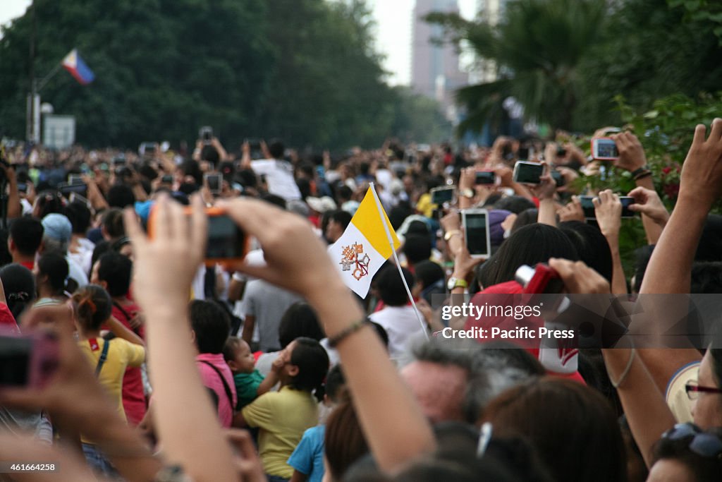 The flag of the vatican among the sea of cellphones and...