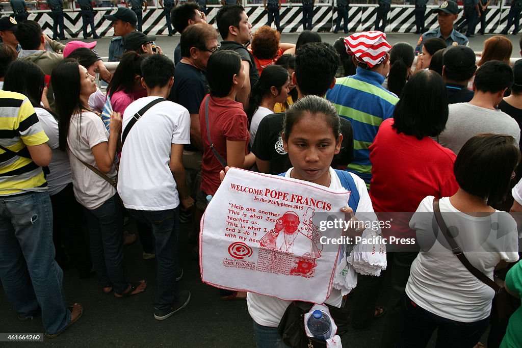 A vendor selling towels as Pope Francis' memomrabilia while...