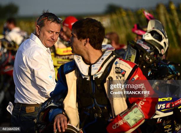 Dakar Rally director Etienne Lavigne speaks with Chilean biker Francisco Errazuriz before the start of the Stage 13 of the Dakar 2015 between Rosario...