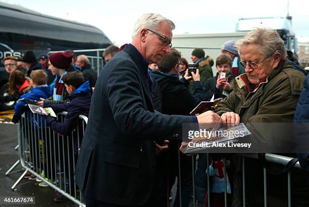 Alan Pardew the manager of Crystal Palace signs autographs as the team arrive at Turf Moor prior to the Barclays Premier League match between Burnley...