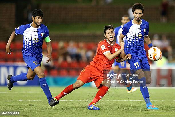 Abdul Aziz Al-Maqbali of Oman contests the ball against Fahed Al Ebrahim and Mesaed Alenzi of Kuwait during the 2015 Asian Cup match between Oman and...