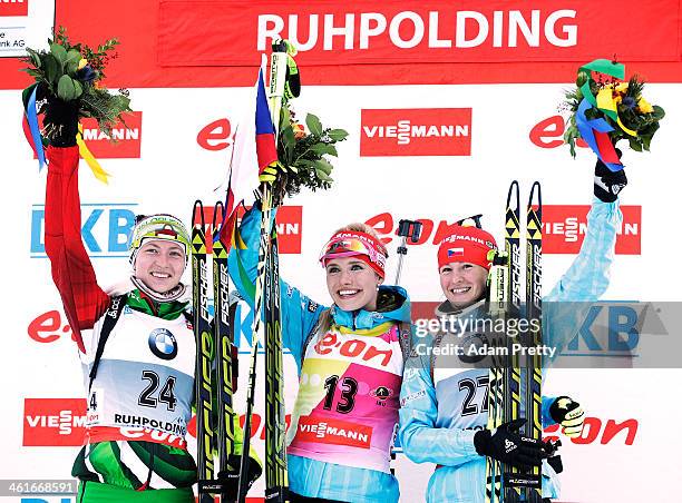 Darya Domracheva of Belarus, Gabriela Soukalova of the Czech Republic and Veronika Vitkova of the Czech Republic celebrate during the flower ceremony...