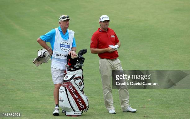 Padraig Harrington of Ireland waits to play his second shot at the par 4, 17th hole with his stand-in caddy Pat Cashman of Ireland who stood in when...