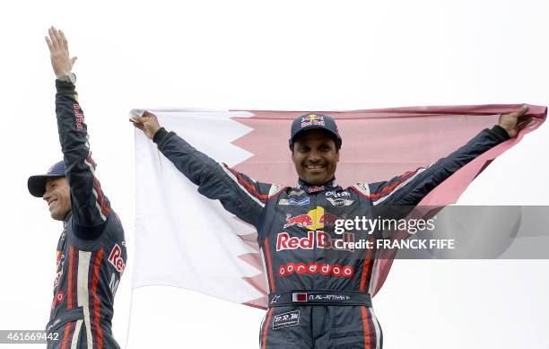 Mini's driver Nasser Al-Attiyah of Qatar and co-driver Mathieu Baumel of France celebrate their victory at he end of the Stage 13 of the Dakar 2015...