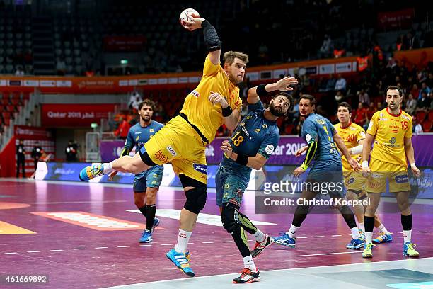 Julen Aguinagalde of Spain shoots over Felipe Ribeiro of Brazil during the IHF Men's Handball World Championship group A match between Brazil and...