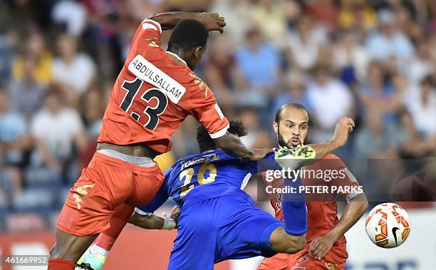 Abdul Sallam Al Mukhaini and Jaber Al Owaisi of Oman tackle Yousef Naser of Kuwait during their Group A football match of the AFC Asian Cup in...