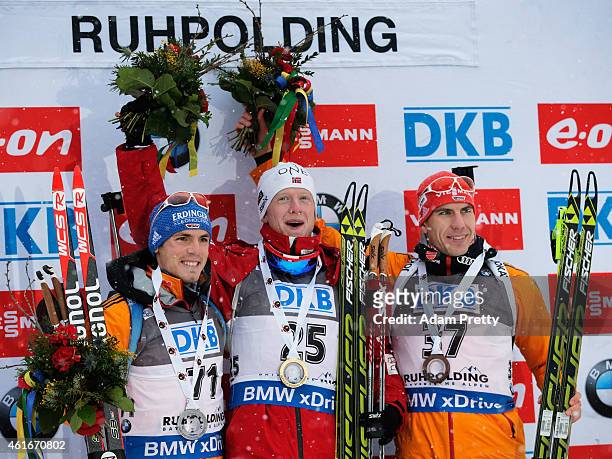 Simon Schempp of Germany second place, Johannes Thingnes Boe of Norway first place and Arnd Peiffer of Germany third place celebrate on the podium...
